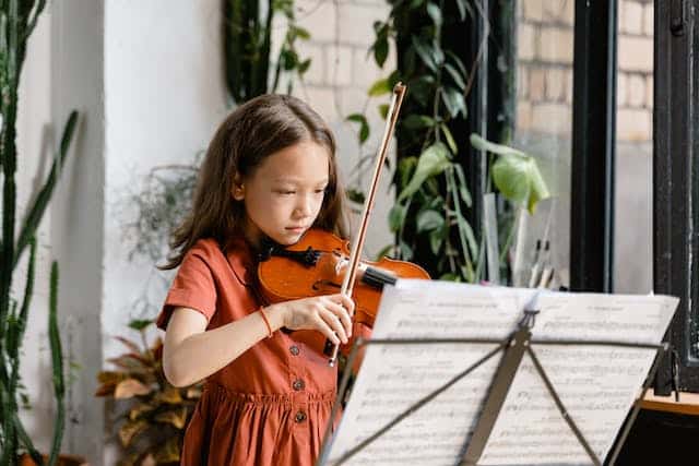 a young girl playing violin