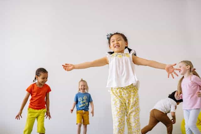 a group of children dancing and playing musical games