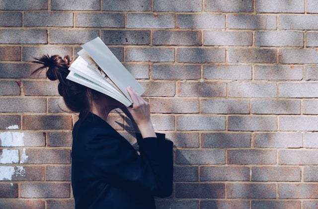 girl with book on head