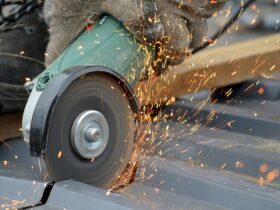 angle grinder with sparks flying on metal roofing