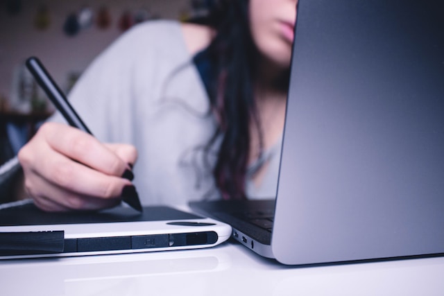 woman doing bills on laptop