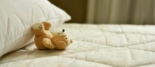 teddy bear on white bedding