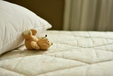 teddy bear on white bedding