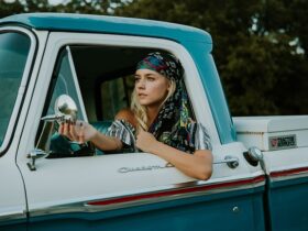 woman driving an old blue truck