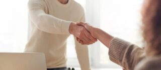 man and woman shaking hands business deal