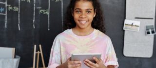 young girl with tablet in school