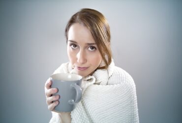 sick woman in blanket ill coffee tea mug