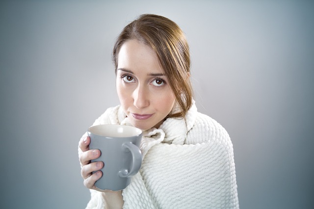 sick woman in blanket ill coffee tea mug