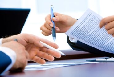 loan paperwork pen business partners
