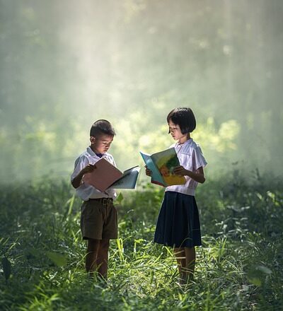 children reading books in forest education school