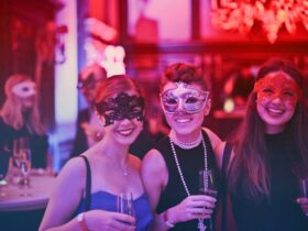 women drinking wine at a masked wine festival