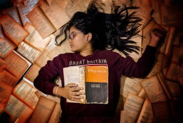 girl sleeping reading physics homework school education