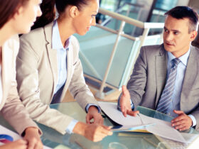 business consultant working with two women in a conference room.