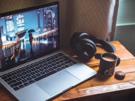laptop and headphones on desk with coffee