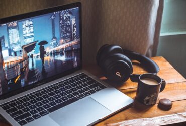 laptop and headphones on desk with coffee