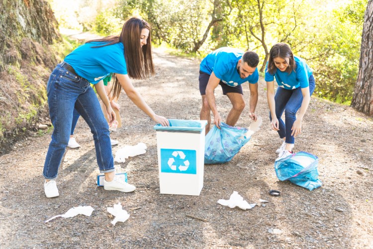 volunteers cleaning up an outdoor walking trail.