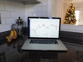 laptop with investment data sitting on counter.