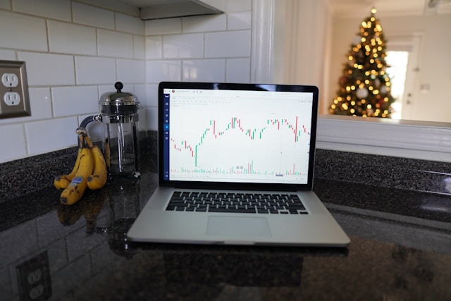 laptop with investment data sitting on counter.
