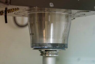CNC Machine milling a piece of metal.