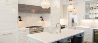 luxury kitchen with island and white cabinets.