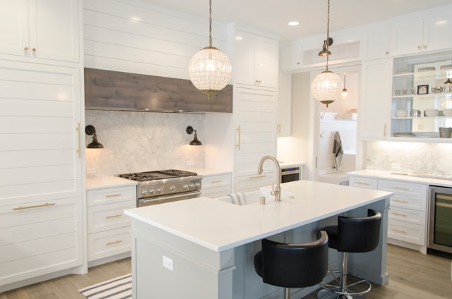 luxury kitchen with island and white cabinets.