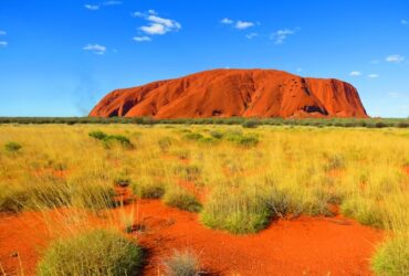 image of the Australian outback with desert in the foreground and a mountain in the background.