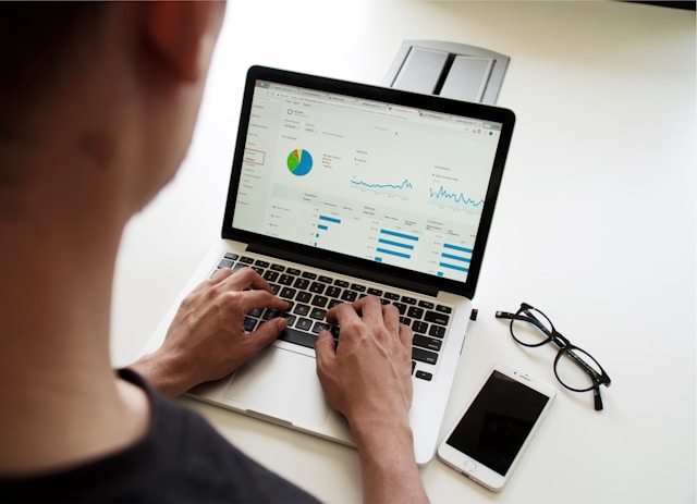 man checking his website statistics on a laptop.