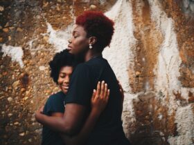 black woman hugging a teen girl.