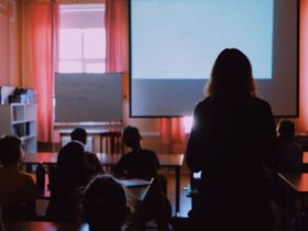 woman standing in a training seminar.