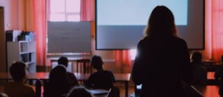 woman standing in a training seminar.