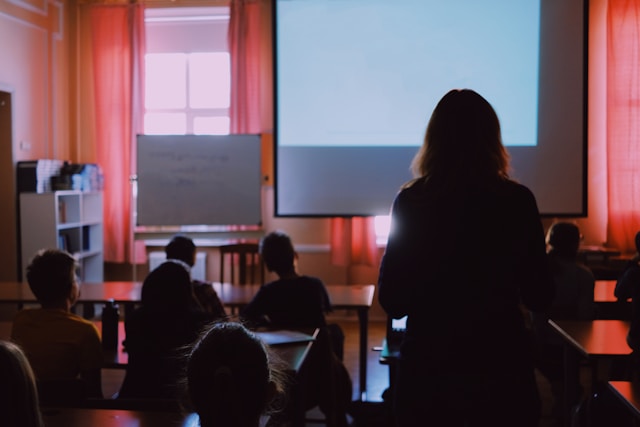 woman standing in a training seminar.