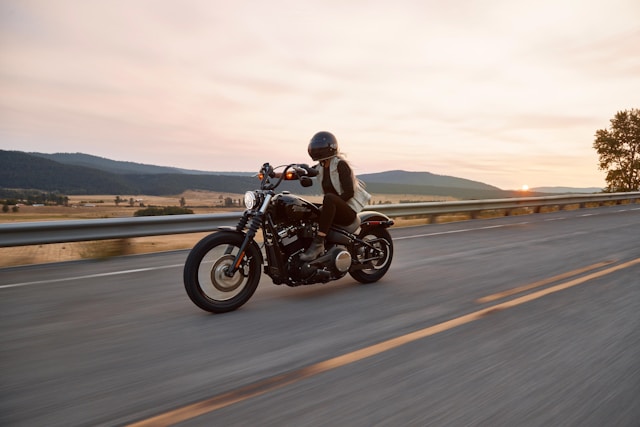 woman driving a motorcycle on the road.