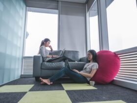 two young women sitting in a lounge area.