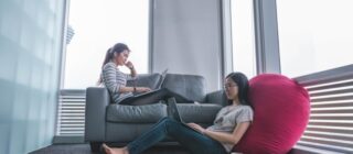 two young women sitting in a lounge area.