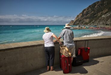 elderly couple on holiday looking out at the ocean.