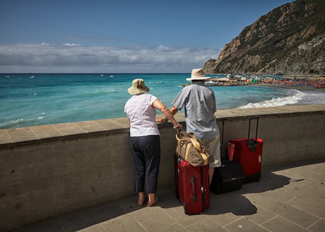 elderly couple on holiday looking out at the ocean.