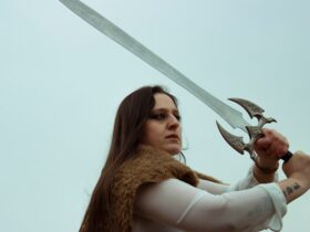 a woman wielding a sword replica.