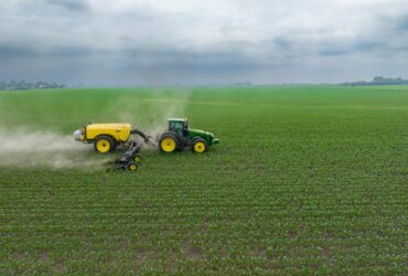 tractor pulling attachments through field.