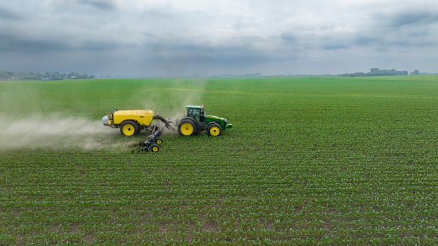 tractor pulling attachments through field.