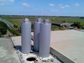 Steel silos mounted on rooftop.