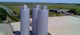 Steel silos mounted on rooftop.