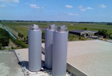 Steel silos mounted on rooftop.