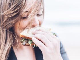 young woman eating a sandwich.