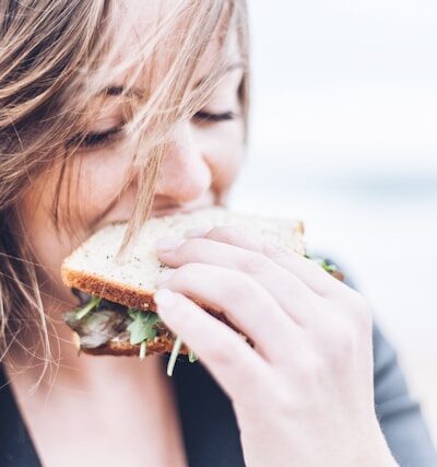 young woman eating a sandwich.