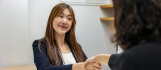 two women shaking hands.