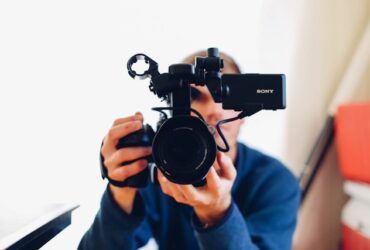 man holding a video camera.