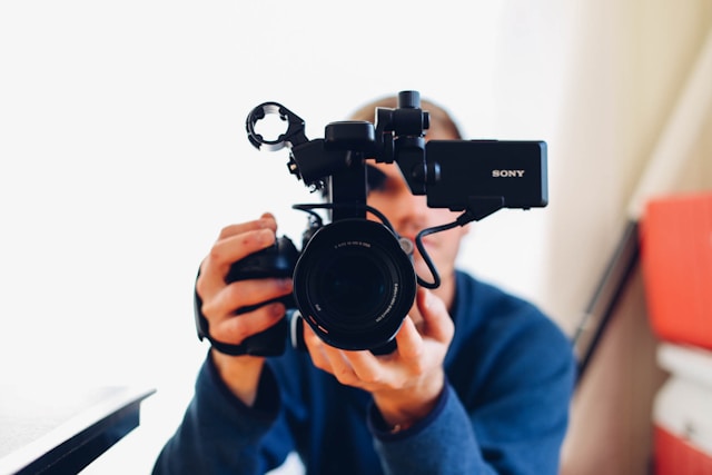 man holding a video camera.