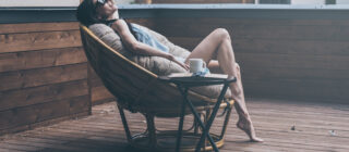 woman in outdoor chair with cup