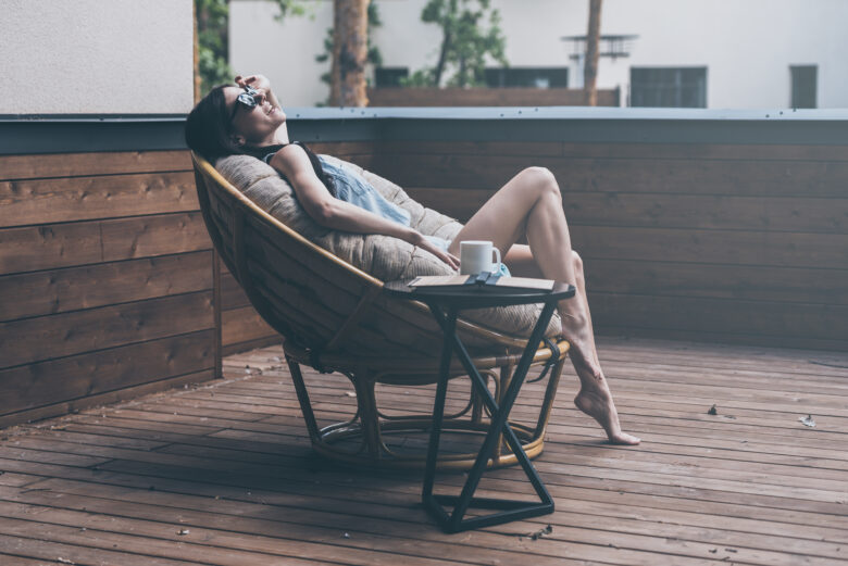 woman in outdoor chair with cup