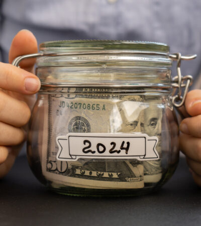 woman's hands holding jar of money